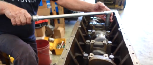 Technician Tightening Main Cap Bolts To Torque Specifications On A Detroit Diesel 671